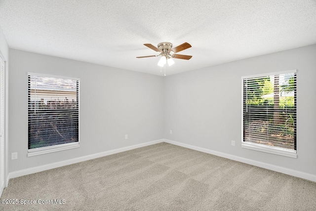 1256 16th Ave SW, Vero Beach, FL 32962 - empty room featuring ceiling fan, carpet, and a textured ceiling