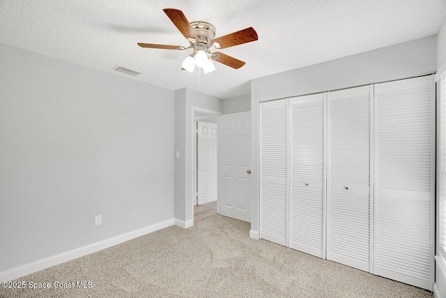 1256 16th Ave SW, Vero Beach, FL 32962 - unfurnished bedroom with light carpet, a closet, ceiling fan, and a textured ceiling
