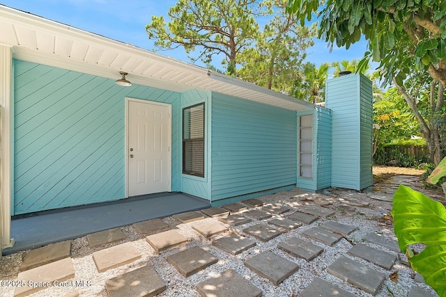1256 16th Ave SW, Vero Beach, FL 32962 - entrance to property featuring a chimney and a patio area