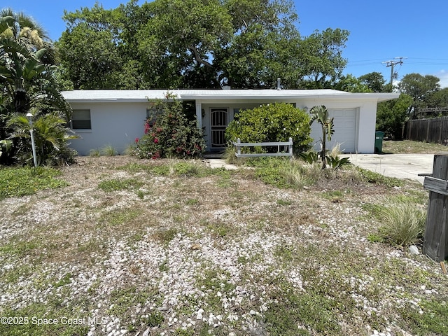 770 2nd Ave, Satellite Beach, FL 32937 - view of front facade with an attached garage, driveway, and stucco siding
