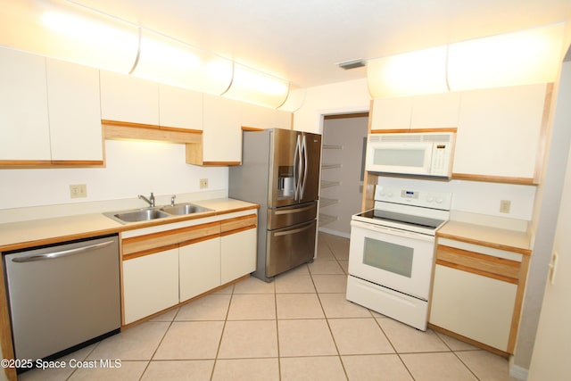 9027 Manchester Ln Unit 22F, West Melbourne, FL 32904 - kitchen featuring stainless steel appliances, light countertops, and light tile patterned floors