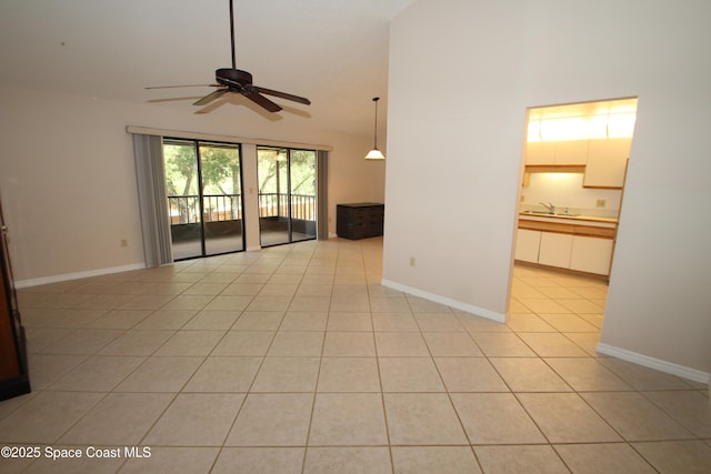 9027 Manchester Ln Unit 22F, West Melbourne, FL 32904 - unfurnished living room with a ceiling fan, light tile patterned floors, and vaulted ceiling