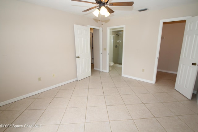 9027 Manchester Ln Unit 22F, West Melbourne, FL 32904 - unfurnished bedroom with a walk in closet, light tile patterned floors, and ceiling fan