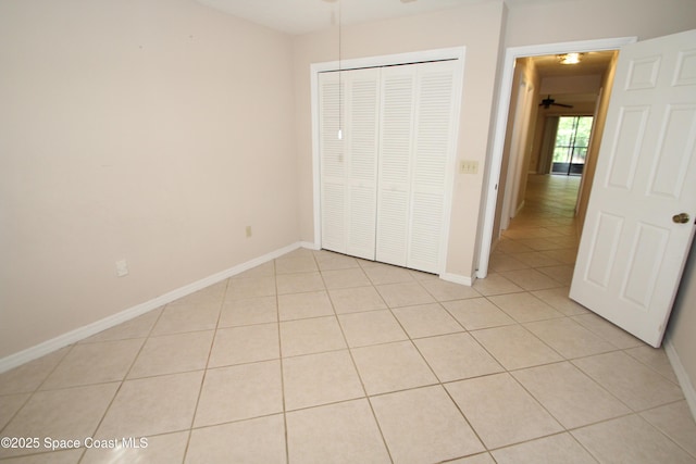 9027 Manchester Ln Unit 22F, West Melbourne, FL 32904 - unfurnished bedroom with light tile patterned floors and a closet