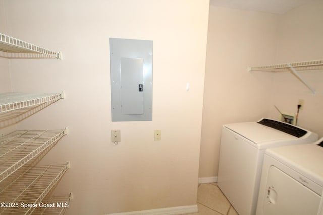 9027 Manchester Ln Unit 22F, West Melbourne, FL 32904 - laundry area featuring electric panel, washer and dryer, and light tile patterned flooring