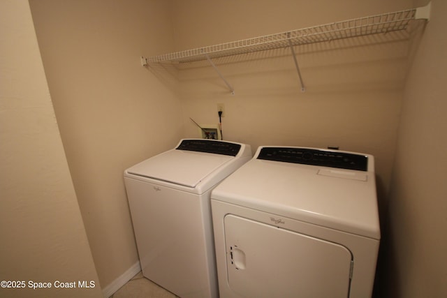9027 Manchester Ln Unit 22F, West Melbourne, FL 32904 - laundry room featuring independent washer and dryer and baseboards