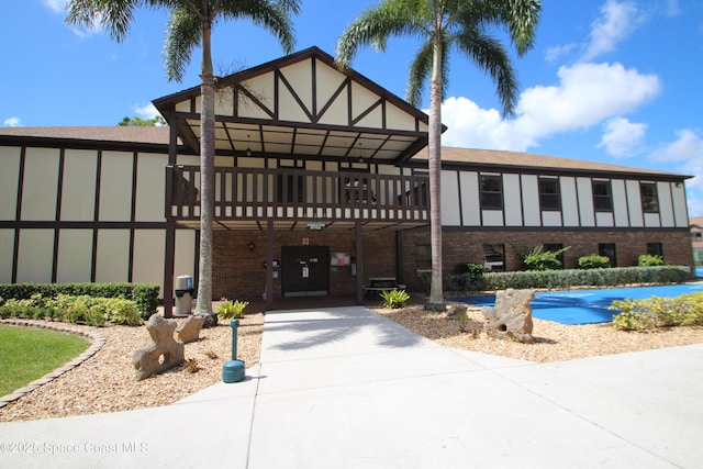 9027 Manchester Ln Unit 22F, West Melbourne, FL 32904 - tudor house featuring concrete driveway and a wooden deck