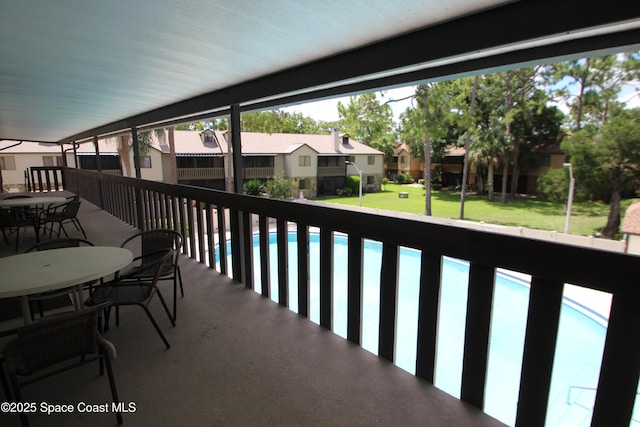 9027 Manchester Ln Unit 22F, West Melbourne, FL 32904 - balcony with a residential view, outdoor dining space, and view of pool area