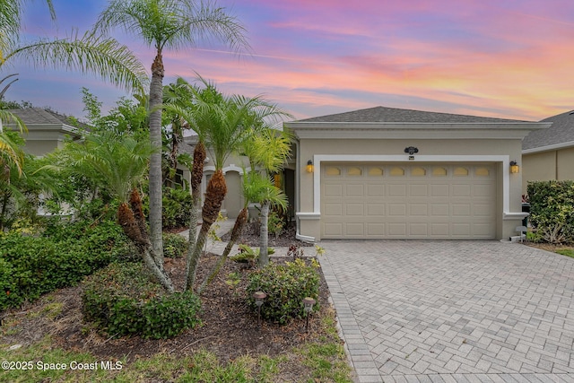 1869 Tullagee Ave, Melbourne, FL 32940 - single story home featuring stucco siding, decorative driveway, and an attached garage