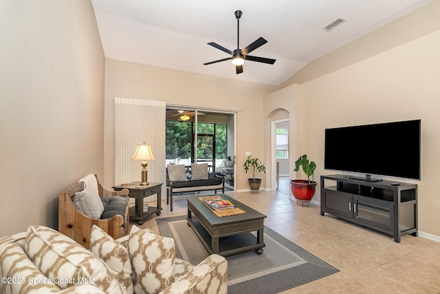 1869 Tullagee Ave, Melbourne, FL 32940 - living room with a ceiling fan, lofted ceiling, light tile patterned floors, and arched walkways