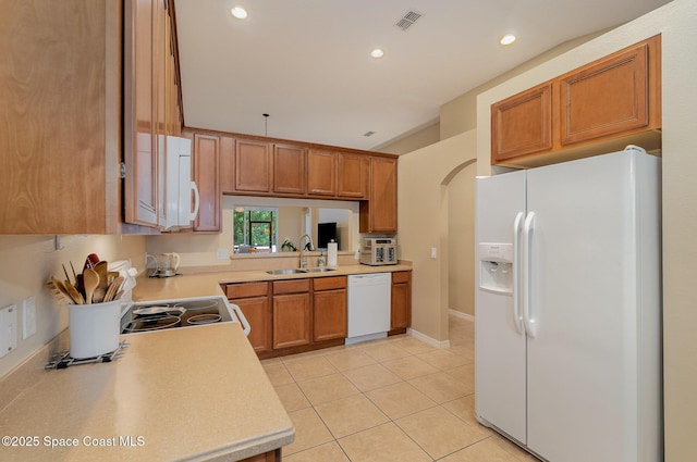 1869 Tullagee Ave, Melbourne, FL 32940 - kitchen featuring white appliances, light countertops, light tile patterned floors, recessed lighting, and brown cabinetry