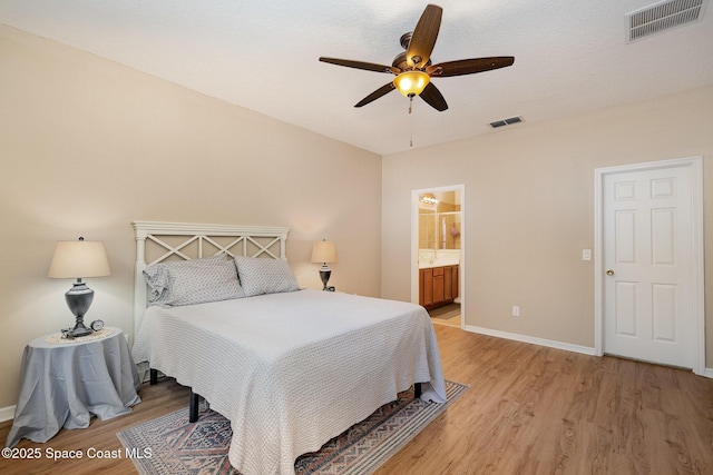 1869 Tullagee Ave, Melbourne, FL 32940 - bedroom featuring light wood-style floors, a ceiling fan, and ensuite bathroom