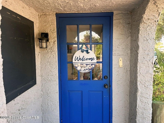 277 Mcleod St, Merritt Island, FL 32953 - entrance to property featuring stucco siding