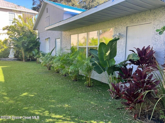 277 Mcleod St, Merritt Island, FL 32953 - view of home's exterior with a lawn and stucco siding
