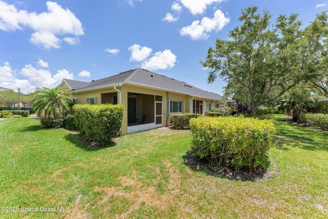 2690 Camberly Cir, Melbourne, FL 32940 - rear view of house featuring a lawn, a sunroom, and a ceiling fan