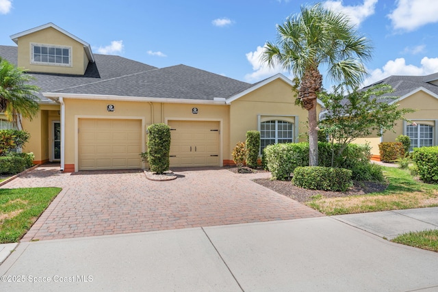 2690 Camberly Cir, Melbourne, FL 32940 - view of front of property with a garage, stucco siding, decorative driveway, and a shingled roof