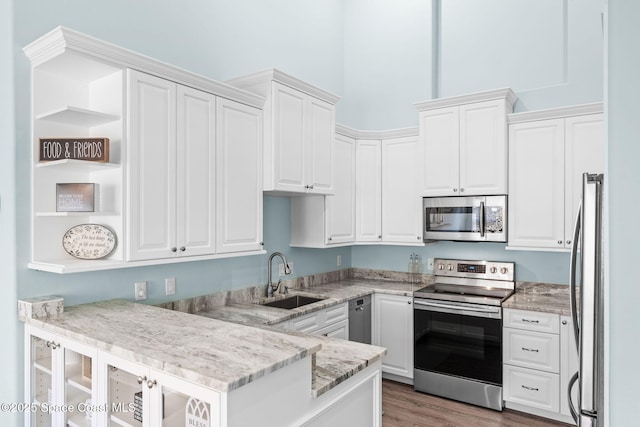 2690 Camberly Cir, Melbourne, FL 32940 - kitchen featuring stainless steel appliances, open shelves, a peninsula, and white cabinetry