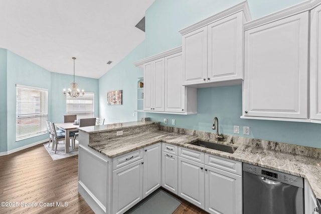2690 Camberly Cir, Melbourne, FL 32940 - kitchen featuring stainless steel dishwasher, a peninsula, vaulted ceiling, white cabinetry, and dark wood-style floors