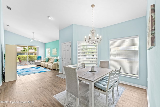 2690 Camberly Cir, Melbourne, FL 32940 - dining space featuring light wood-style flooring, a chandelier, ceiling fan, and vaulted ceiling