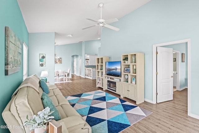 2690 Camberly Cir, Melbourne, FL 32940 - living room featuring wood finished floors, high vaulted ceiling, a ceiling fan, and arched walkways