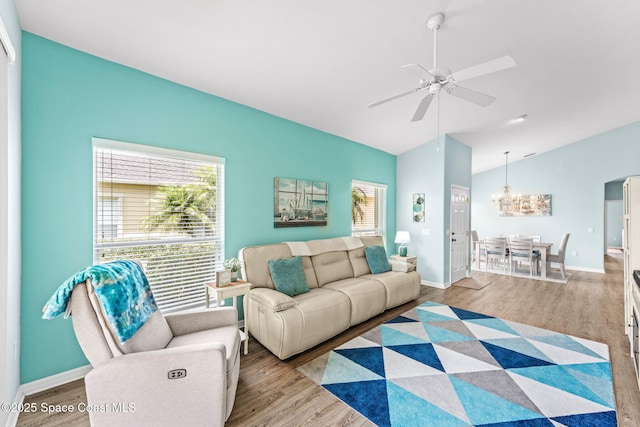 2690 Camberly Cir, Melbourne, FL 32940 - living room featuring lofted ceiling, wood finished floors, ceiling fan, and a chandelier
