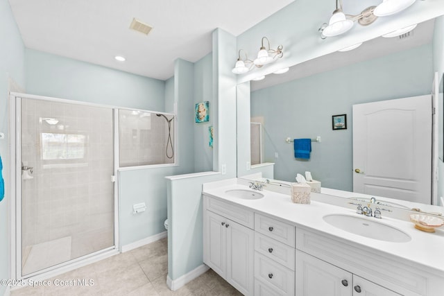 2690 Camberly Cir, Melbourne, FL 32940 - bathroom featuring a stall shower, double vanity, and tile patterned flooring