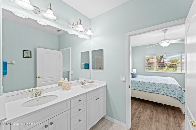 2690 Camberly Cir, Melbourne, FL 32940 - ensuite bathroom featuring double vanity, ceiling fan, and wood finished floors