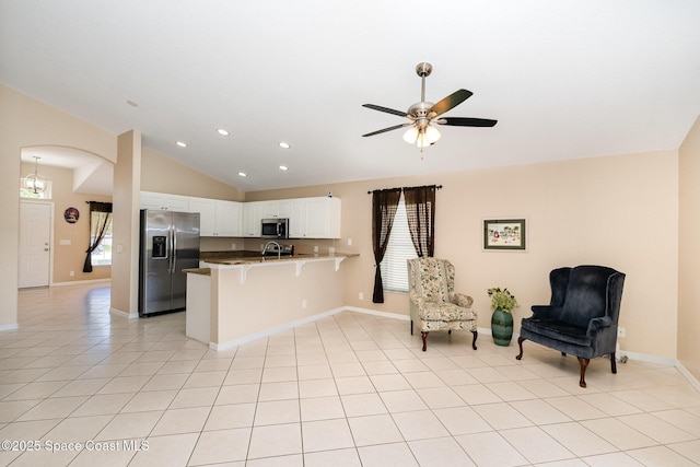 2383 Glasbern Cir, Melbourne, FL 32904 - kitchen with appliances with stainless steel finishes, a peninsula, open floor plan, vaulted ceiling, and a breakfast bar area