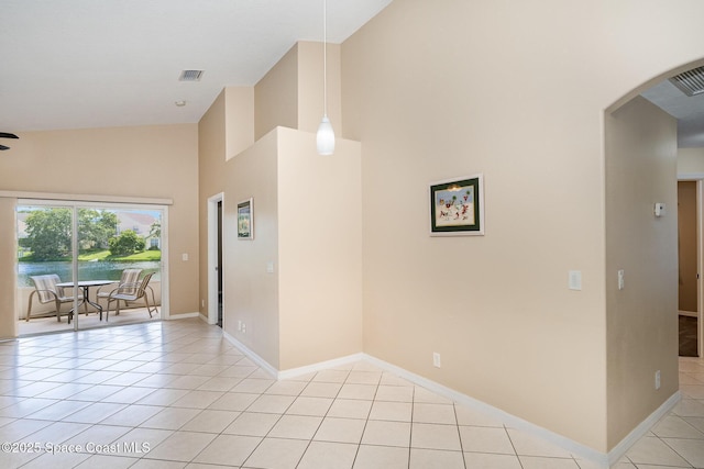 2383 Glasbern Cir, Melbourne, FL 32904 - empty room featuring arched walkways, high vaulted ceiling, and light tile patterned floors