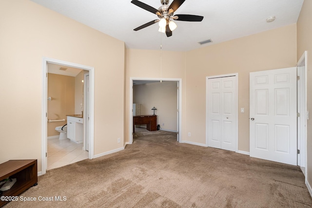2383 Glasbern Cir, Melbourne, FL 32904 - unfurnished bedroom with carpet floors, a closet, ensuite bathroom, and ceiling fan
