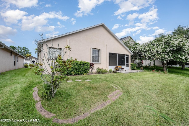 2383 Glasbern Cir, Melbourne, FL 32904 - back of property featuring stucco siding, a yard, and a sunroom
