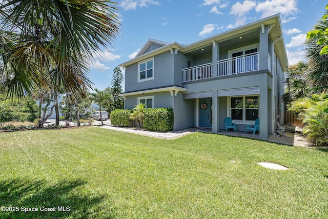 120 Heron Dr, Melbourne Beach, FL 32951 - rear view of property with a balcony and stucco siding