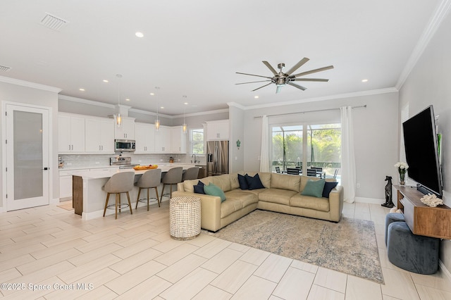 120 Heron Dr, Melbourne Beach, FL 32951 - living room featuring a ceiling fan, recessed lighting, and crown molding