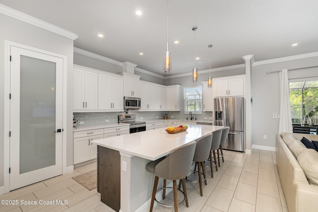 120 Heron Dr, Melbourne Beach, FL 32951 - kitchen featuring stainless steel appliances, tasteful backsplash, white cabinets, light countertops, and recessed lighting