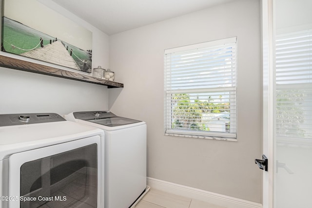 120 Heron Dr, Melbourne Beach, FL 32951 - laundry area with washing machine and dryer and light tile patterned flooring