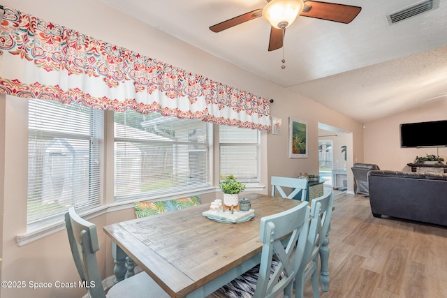 7045 Grissom Pkwy, Cocoa, FL 32927 - dining room with healthy amount of natural light, vaulted ceiling, light wood-style floors, and a ceiling fan