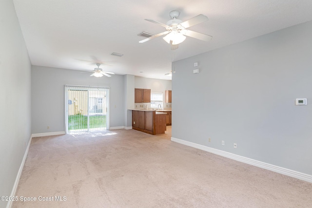609 Cedar Side Cir NE, Palm Bay, FL 32905 - unfurnished living room with ceiling fan and light carpet