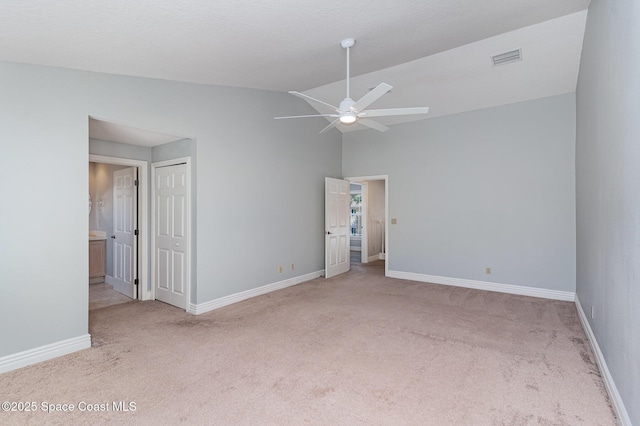 609 Cedar Side Cir NE, Palm Bay, FL 32905 - unfurnished bedroom featuring carpet, a closet, connected bathroom, and high vaulted ceiling