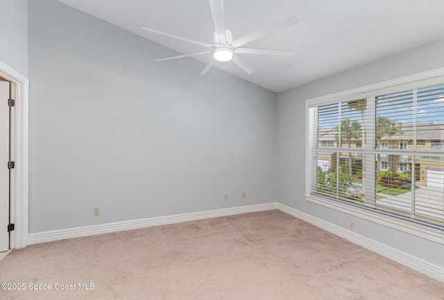 609 Cedar Side Cir NE, Palm Bay, FL 32905 - empty room with light carpet, vaulted ceiling, and a ceiling fan