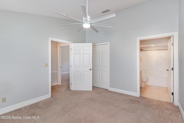 609 Cedar Side Cir NE, Palm Bay, FL 32905 - unfurnished bedroom with carpet flooring, a closet, and ensuite bath