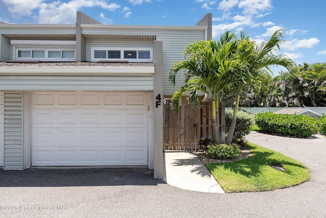 1708 Atlantic St Unit 4F, Melbourne Beach, FL 32951 - garage with asphalt driveway