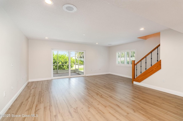 1708 Atlantic St Unit 4F, Melbourne Beach, FL 32951 - empty room featuring light wood finished floors, recessed lighting, and stairway