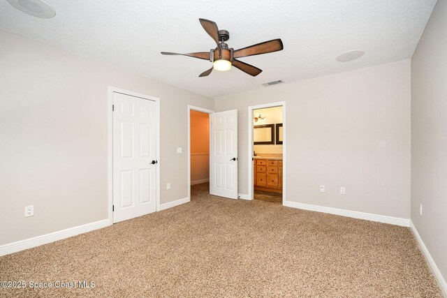 1708 Atlantic St Unit 4F, Melbourne Beach, FL 32951 - unfurnished bedroom featuring light colored carpet, ensuite bathroom, and ceiling fan