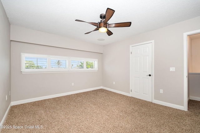 1708 Atlantic St Unit 4F, Melbourne Beach, FL 32951 - unfurnished bedroom featuring carpet floors, multiple windows, ceiling fan, and a textured ceiling