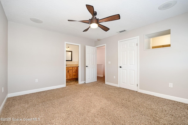 1708 Atlantic St Unit 4F, Melbourne Beach, FL 32951 - unfurnished bedroom with light carpet, a closet, connected bathroom, and ceiling fan
