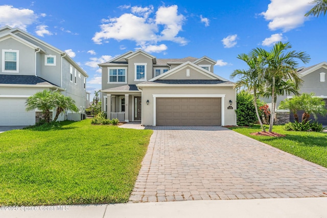 3089 Ribbon Grass Dr, Melbourne, FL 32940 - traditional-style home with stucco siding, decorative driveway, a front yard, and an attached garage