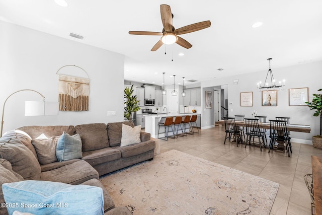 3089 Ribbon Grass Dr, Melbourne, FL 32940 - living room featuring a ceiling fan, light tile patterned floors, a chandelier, and recessed lighting