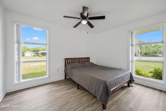 1056 Noreen Blvd, Rockledge, FL 32955 - bedroom featuring light wood-type flooring, multiple windows, and ceiling fan
