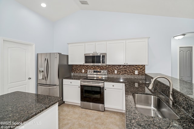 183 Frante Ave NE, Palm Bay, FL 32907 - kitchen with appliances with stainless steel finishes, white cabinets, high vaulted ceiling, backsplash, and light tile patterned floors