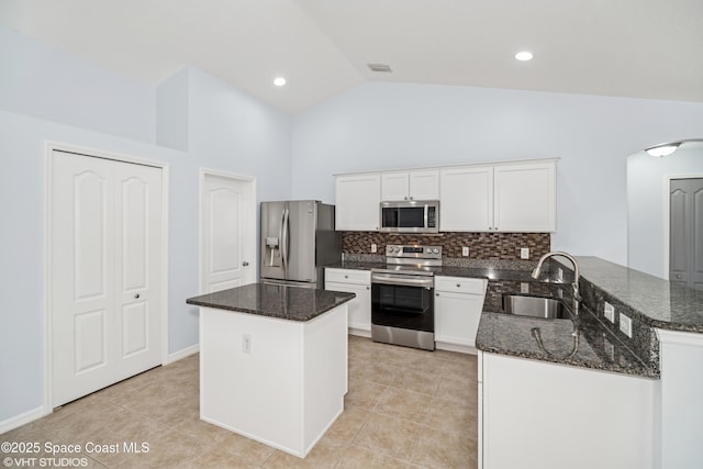 183 Frante Ave NE, Palm Bay, FL 32907 - kitchen featuring appliances with stainless steel finishes, arched walkways, decorative backsplash, dark stone countertops, and high vaulted ceiling